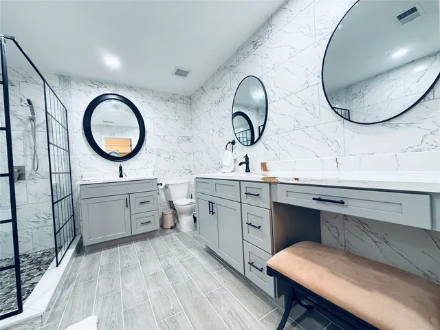 a bathroom with a double vanity sink and a mirror