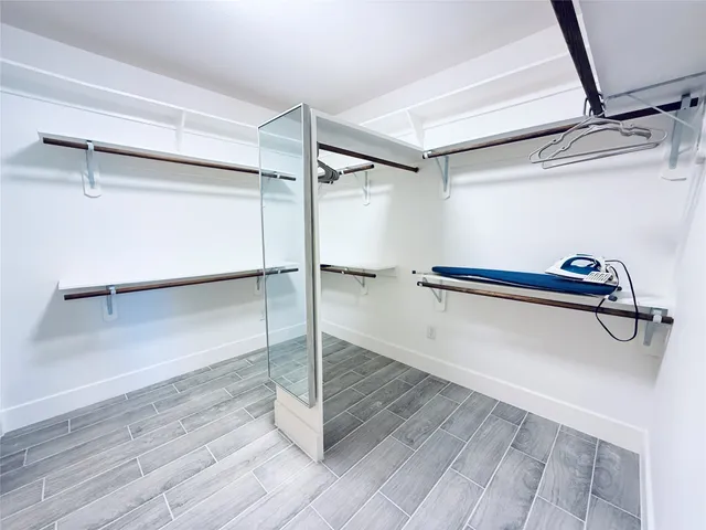 a view of a room with wooden floor