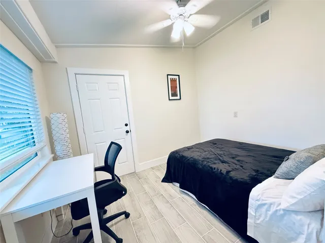 a bedroom with a bed and a desk
