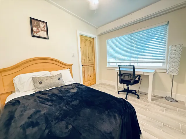 a bedroom with a bed and a window