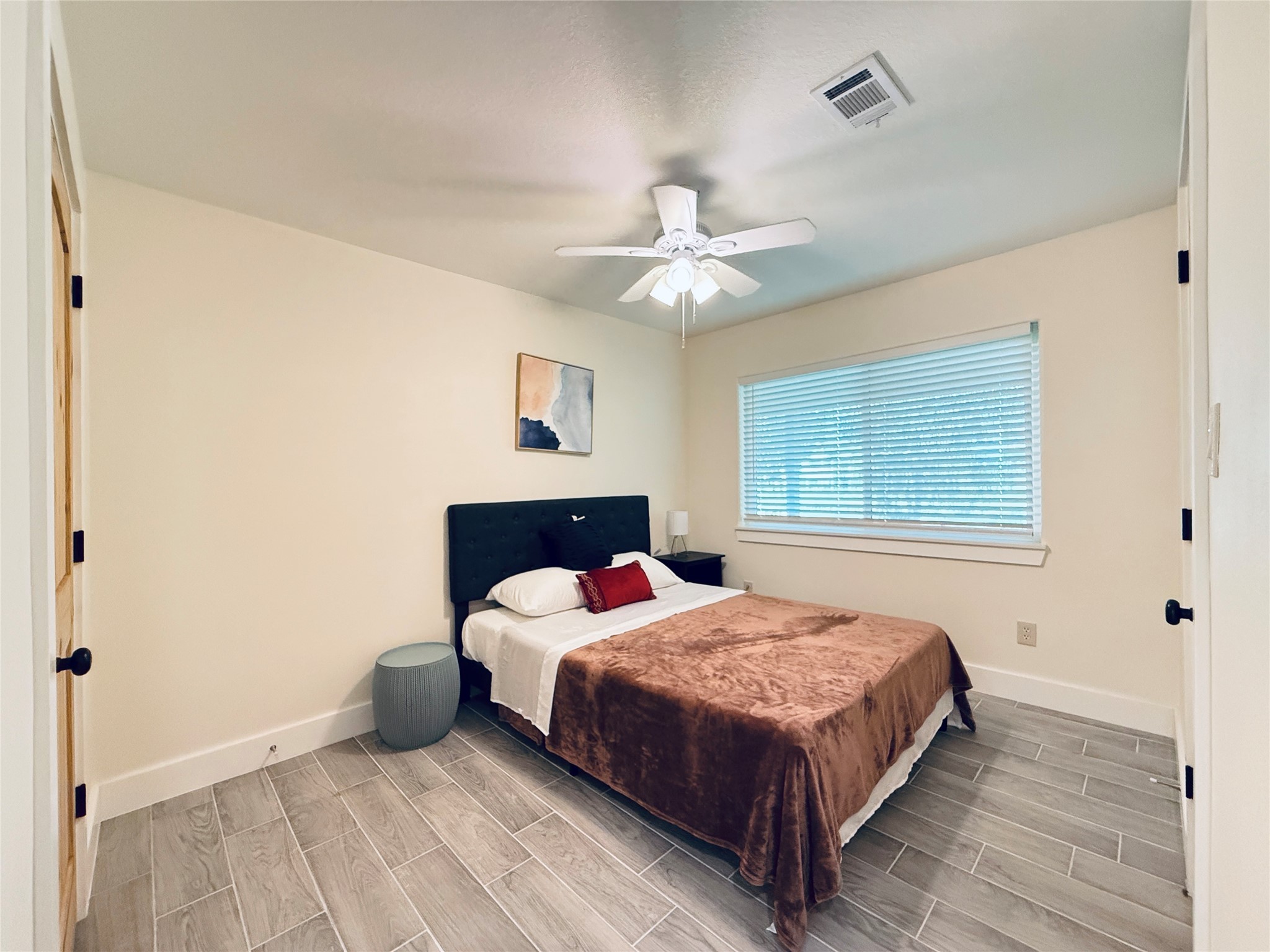 3936 Wagon Road Dickinson, TX 77539 - Photo 25 of 45 a bedroom with a bed chandelier and a window