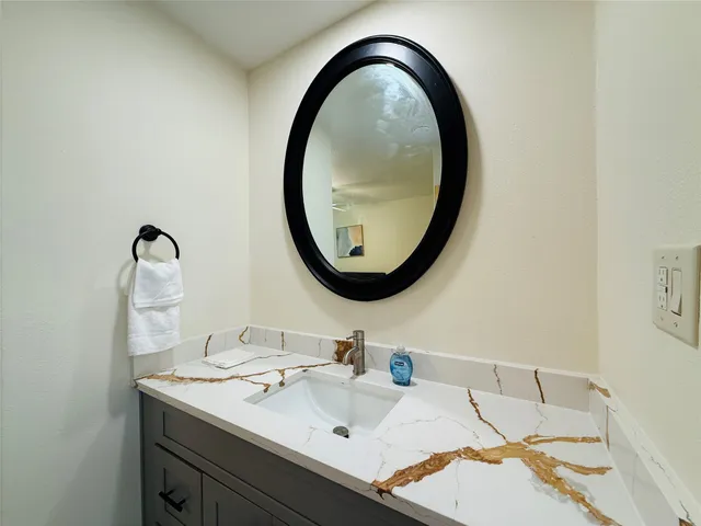 a bathroom with a sink and a mirror