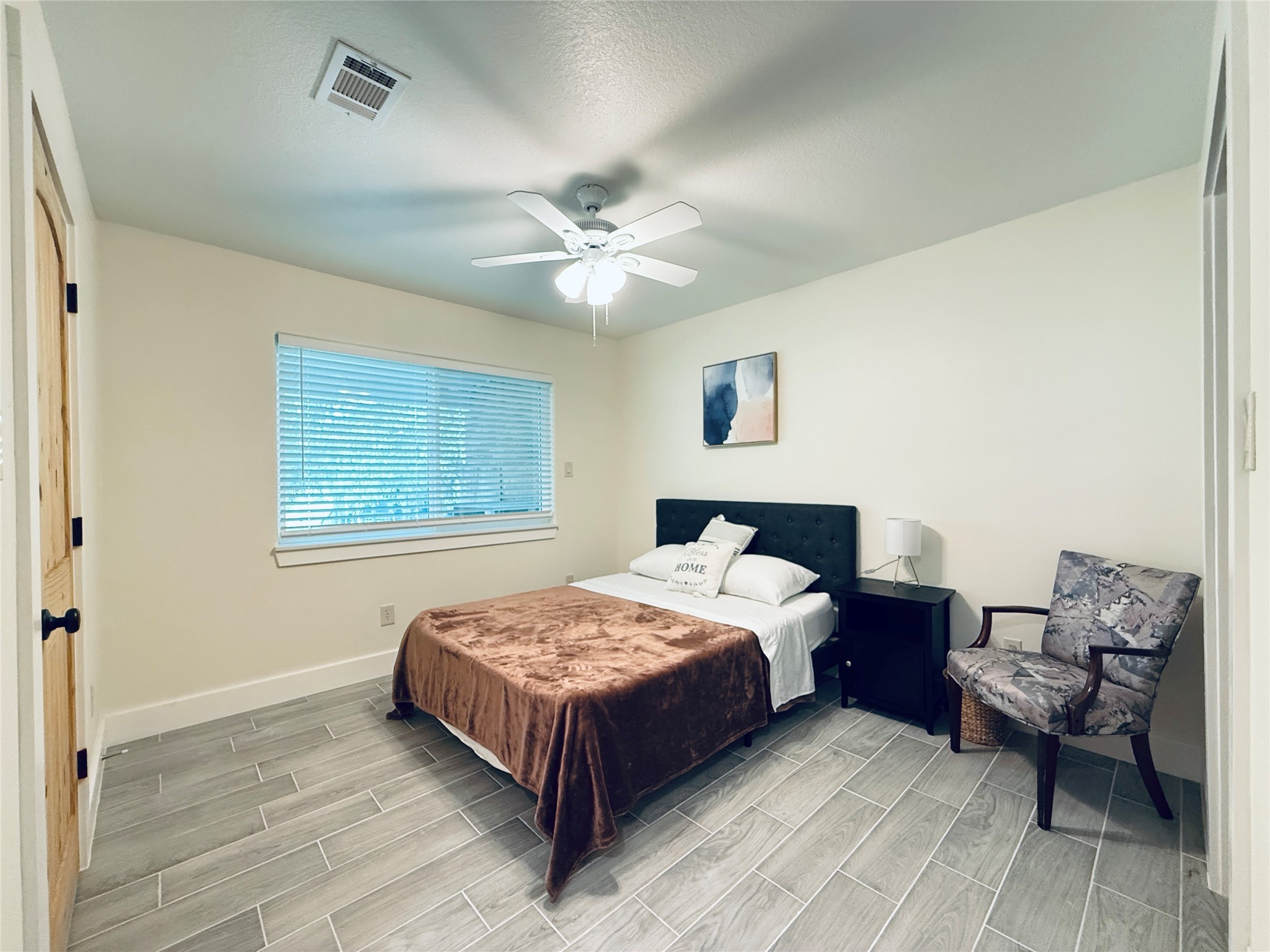 3936 Wagon Road Dickinson, TX 77539 - Photo 30 of 45 a bedroom with a bed chandelier and window