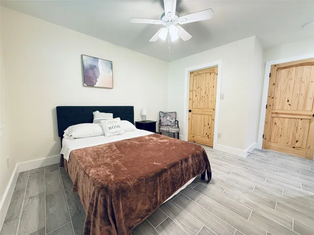 a bedroom with a bed and a chandelier