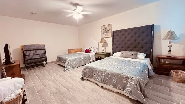 a bedroom with two beds and a chandelier