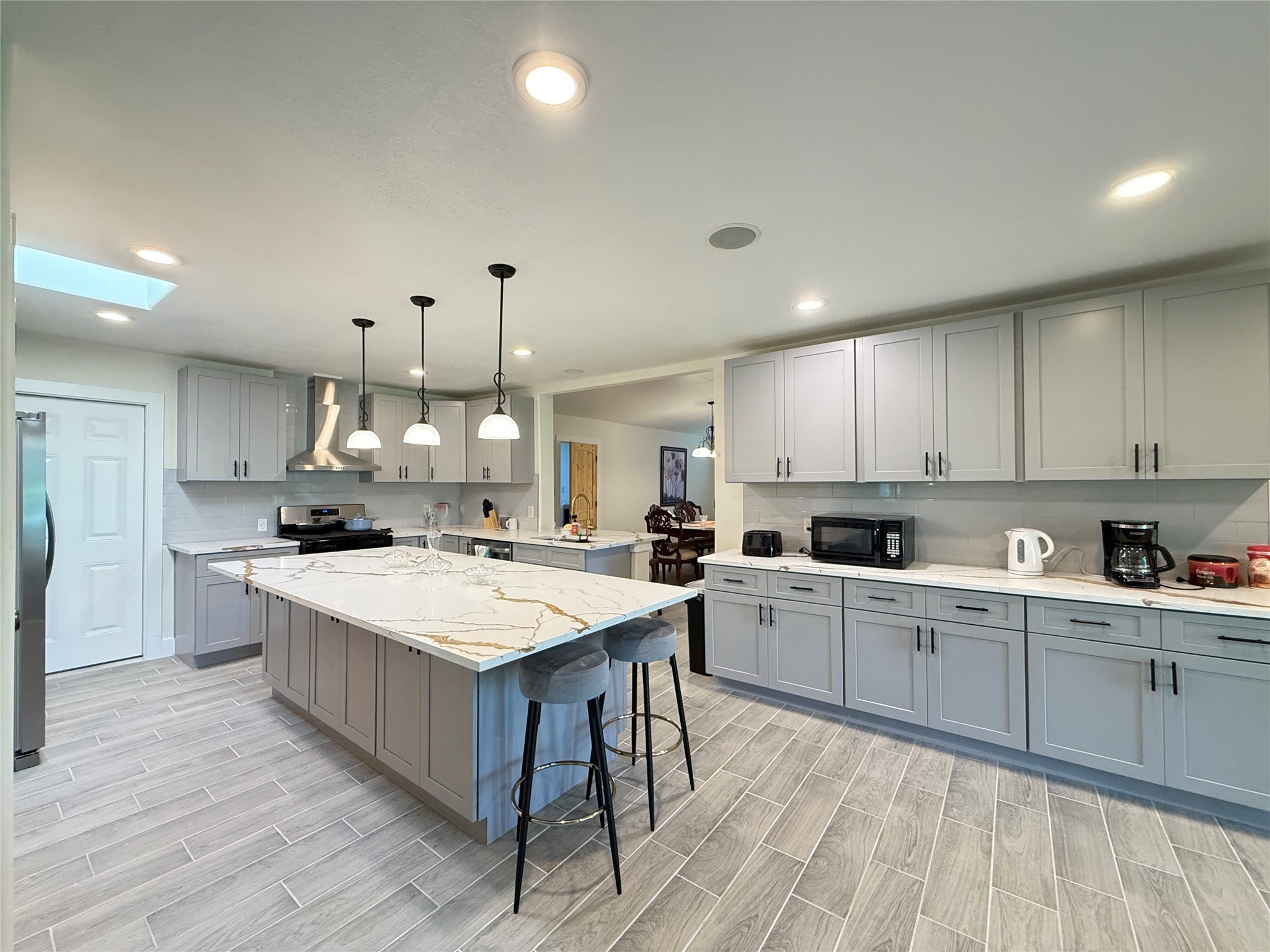 3936 Wagon Road Dickinson, TX 77539 - Photo 4 of 45 a large white kitchen with wooden floors and white cabinets