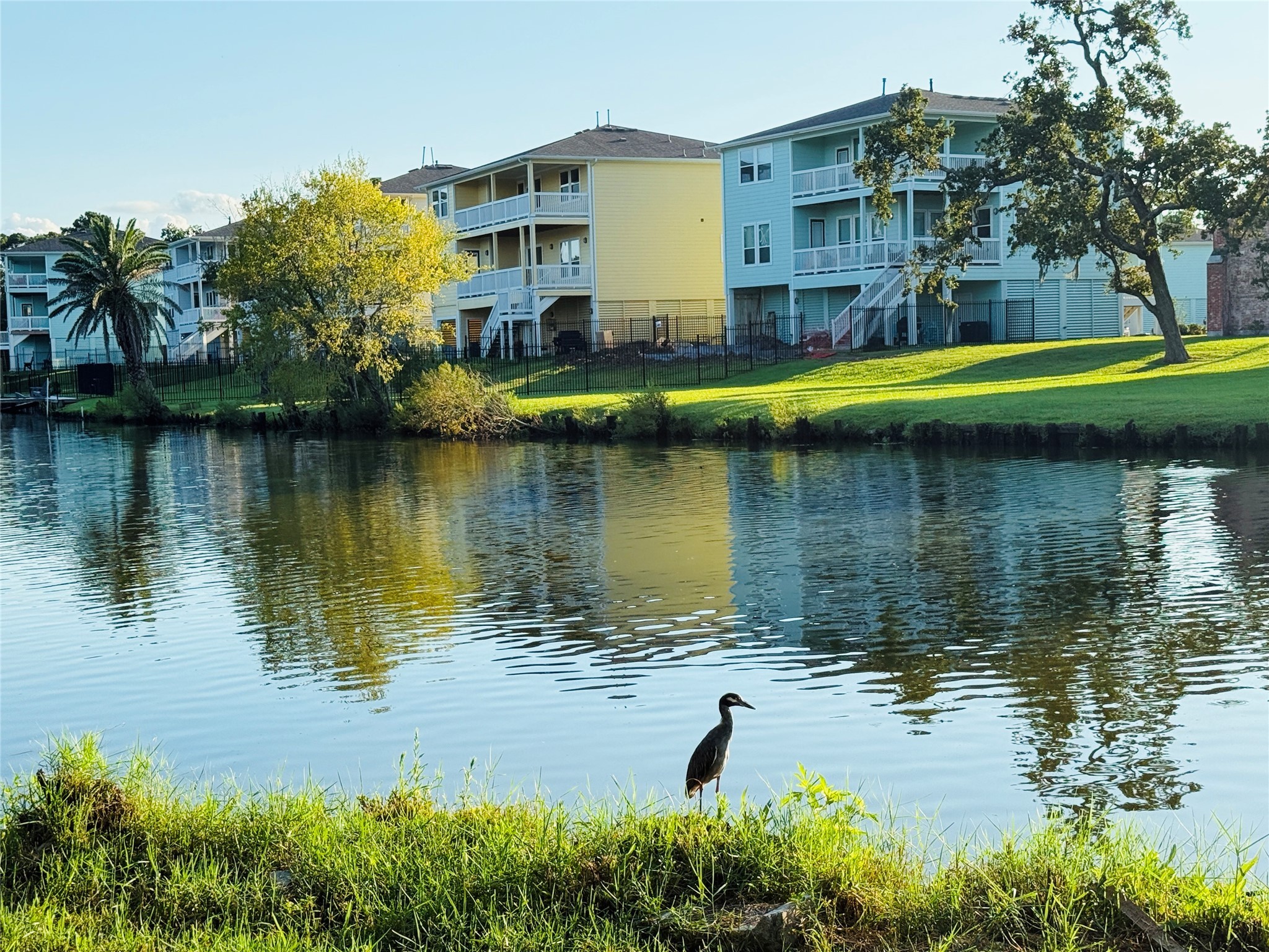 3936 Wagon Road Dickinson, TX 77539 - Photo 42 of 45 a view of a lake with a building in the background