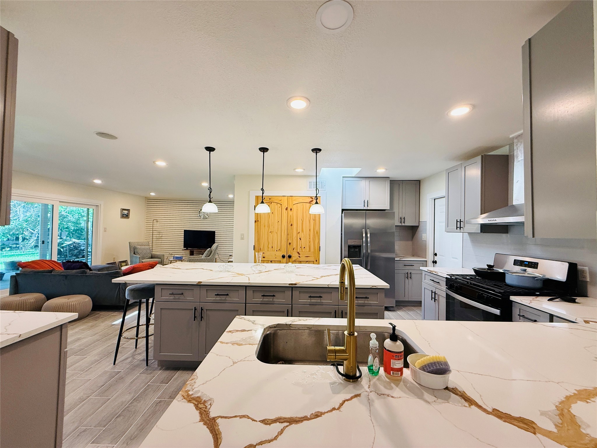 3936 Wagon Road Dickinson, TX 77539 - Photo 5 of 45 a kitchen with kitchen island granite countertop a sink counter top space appliances and cabinets