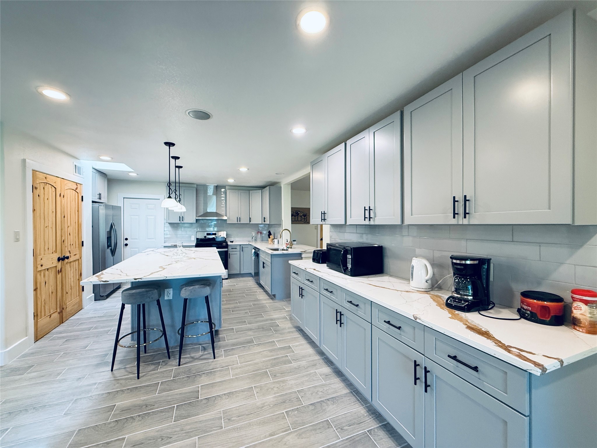 3936 Wagon Road Dickinson, TX 77539 - Photo 8 of 45 a kitchen with a sink a cabinets and wooden floor