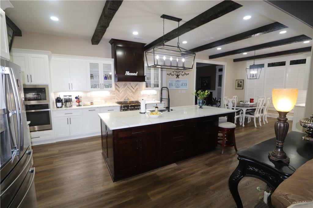 3251 Lenora Church Road Snellville, GA 30039 - Photo 11 of 48 a kitchen with a sink stainless steel appliances and cabinets