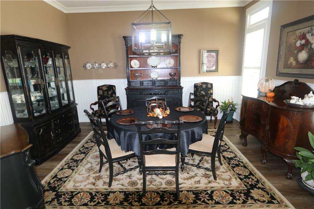 3251 Lenora Church Road Snellville, GA 30039 - Photo 13 of 48 a dining room with furniture a rug and wooden floor