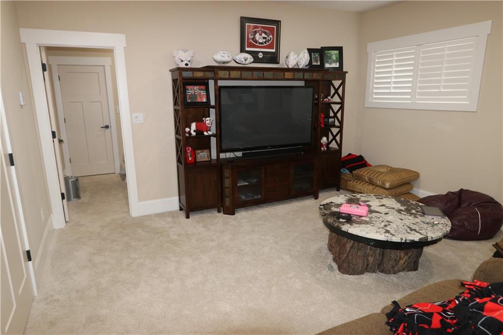 3251 Lenora Church Road Snellville, GA 30039 - Photo 26 of 48 a living room with furniture and a flat screen tv