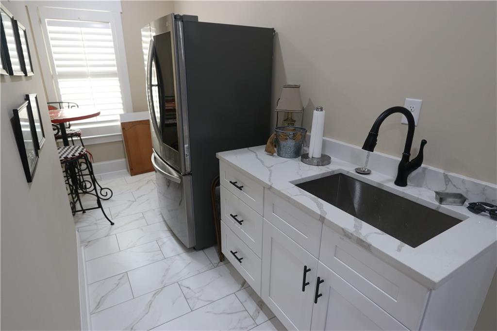 3251 Lenora Church Road Snellville, GA 30039 - Photo 27 of 48 a kitchen with a refrigerator and a stove top oven