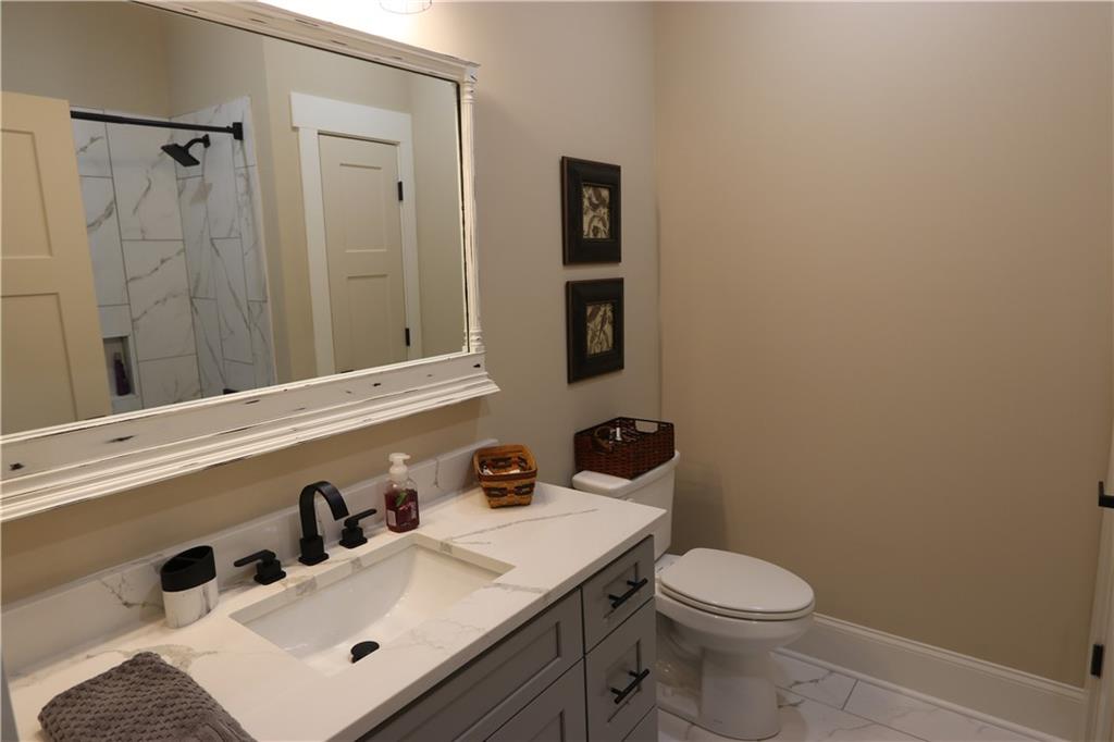 3251 Lenora Church Road Snellville, GA 30039 - Photo 31 of 48 a bathroom with a sink toilet and vanity