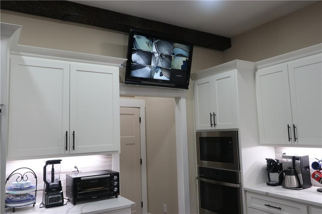 3251 Lenora Church Road Snellville, GA 30039 - Photo 35 of 48 a kitchen with stainless steel appliances a refrigerator and cabinets