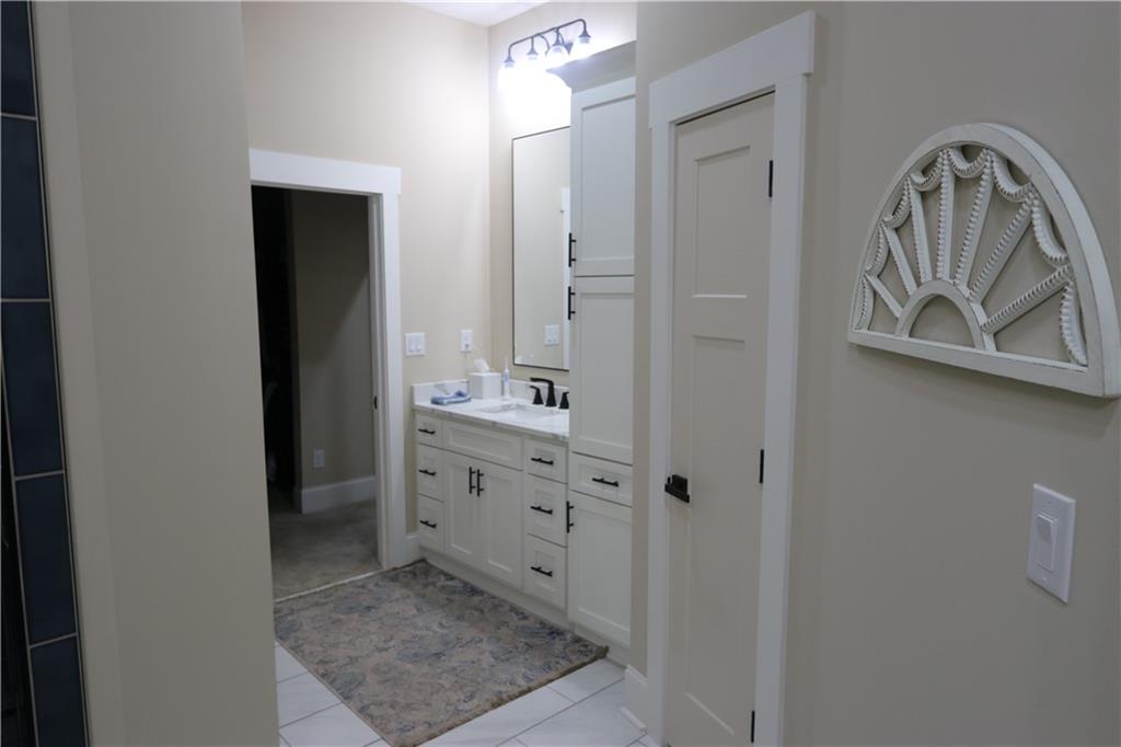 3251 Lenora Church Road Snellville, GA 30039 - Photo 37 of 48 a bathroom with a double vanity sink and mirror