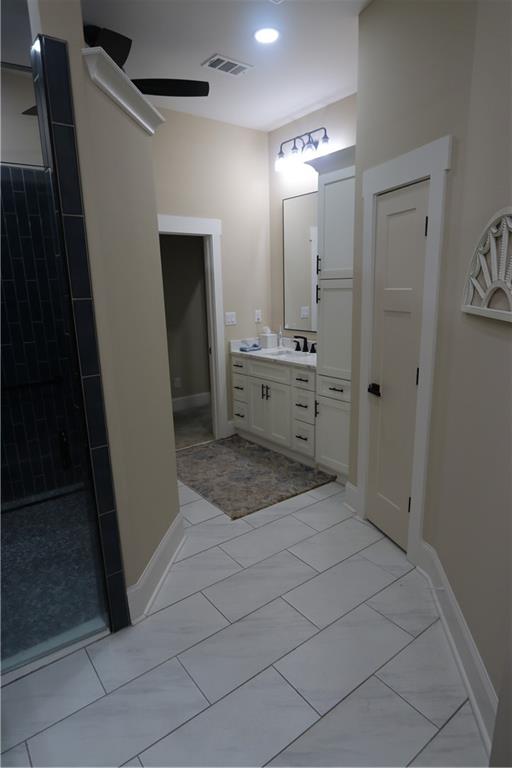 3251 Lenora Church Road Snellville, GA 30039 - Photo 39 of 48 a bathroom with a sink a mirror and a shower