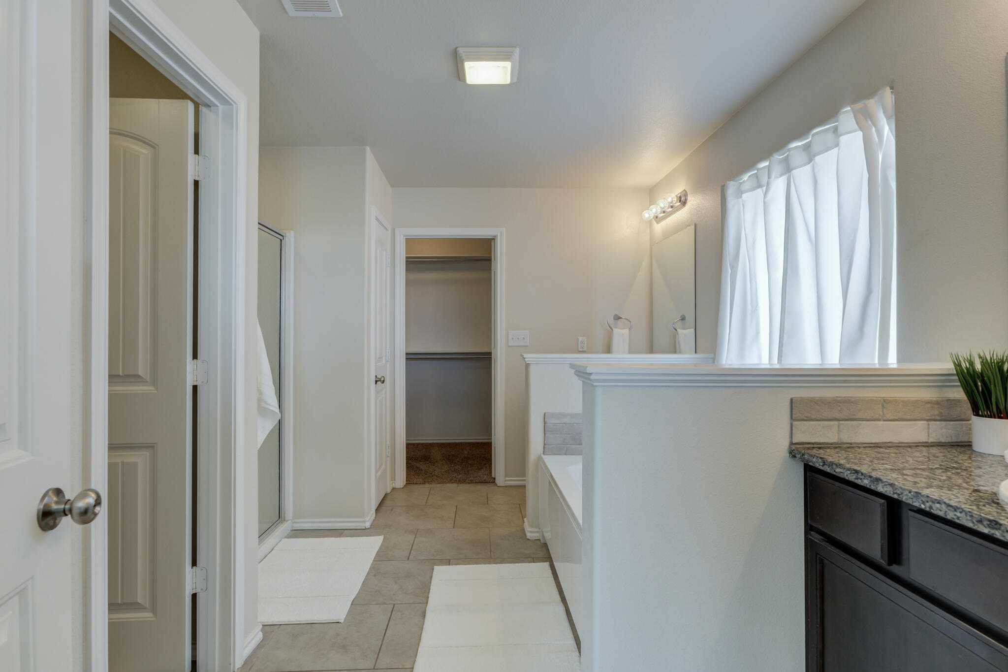 7201 94th Street Lubbock, TX 79424 - Photo 20 of 34 a bathroom with a granite countertop sink and a mirror