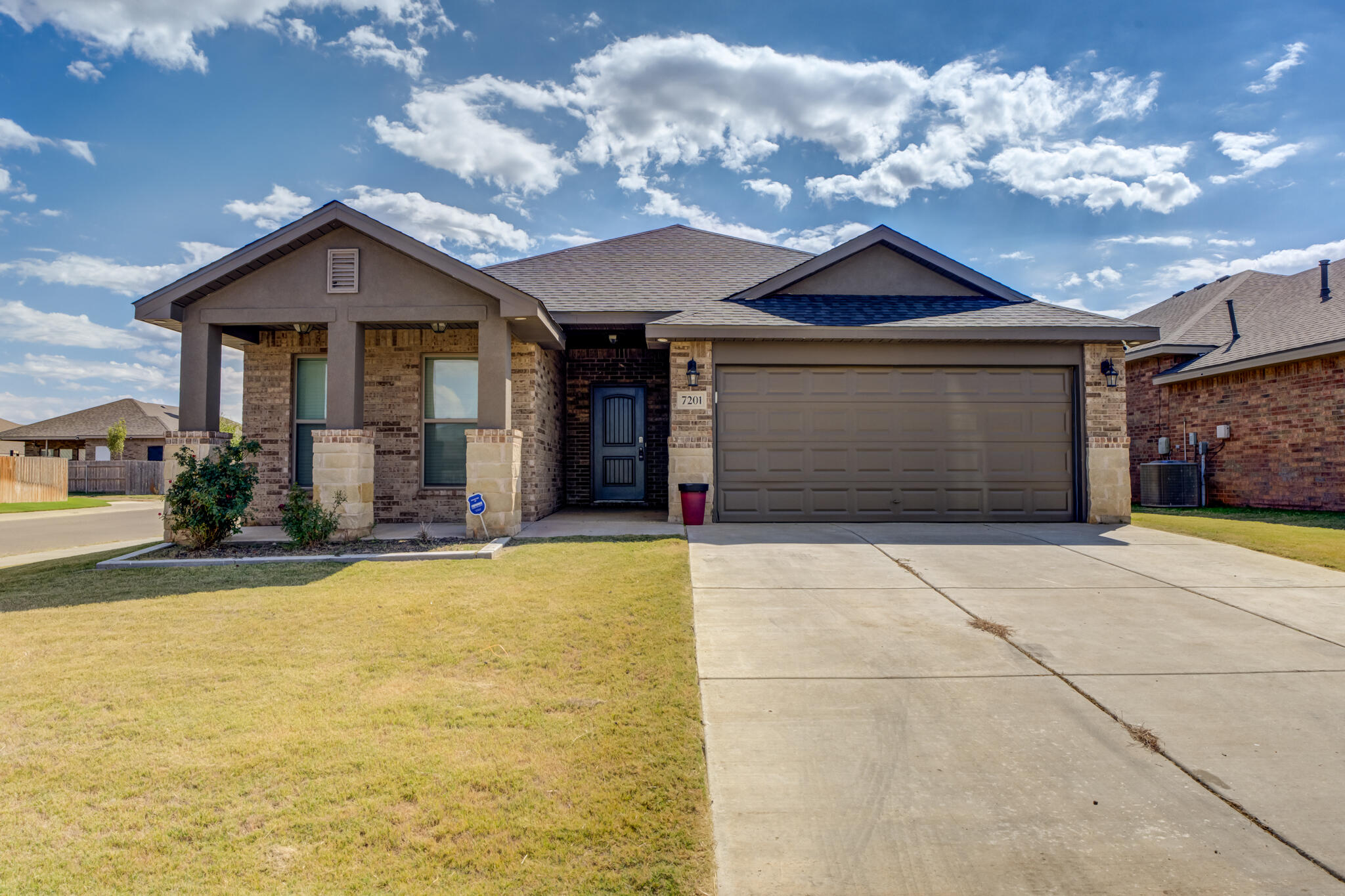 7201 94th Street Lubbock, TX 79424 - Photo 2 of 34 a front view of a house with yard