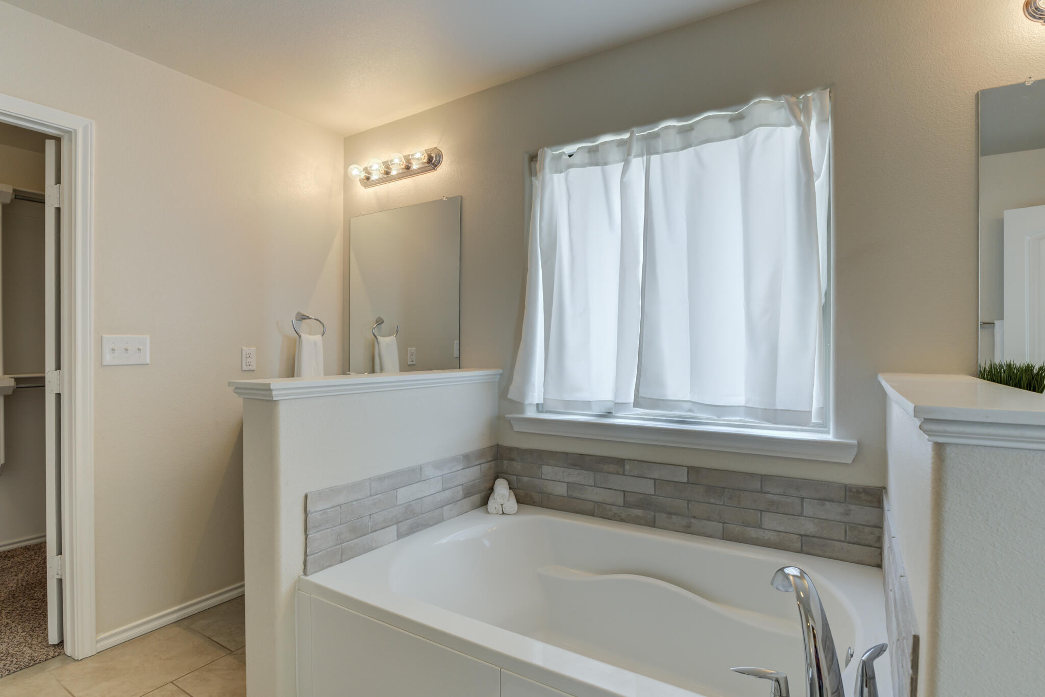 7201 94th Street Lubbock, TX 79424 - Photo 22 of 34 a bathroom with a bathtub and a shower