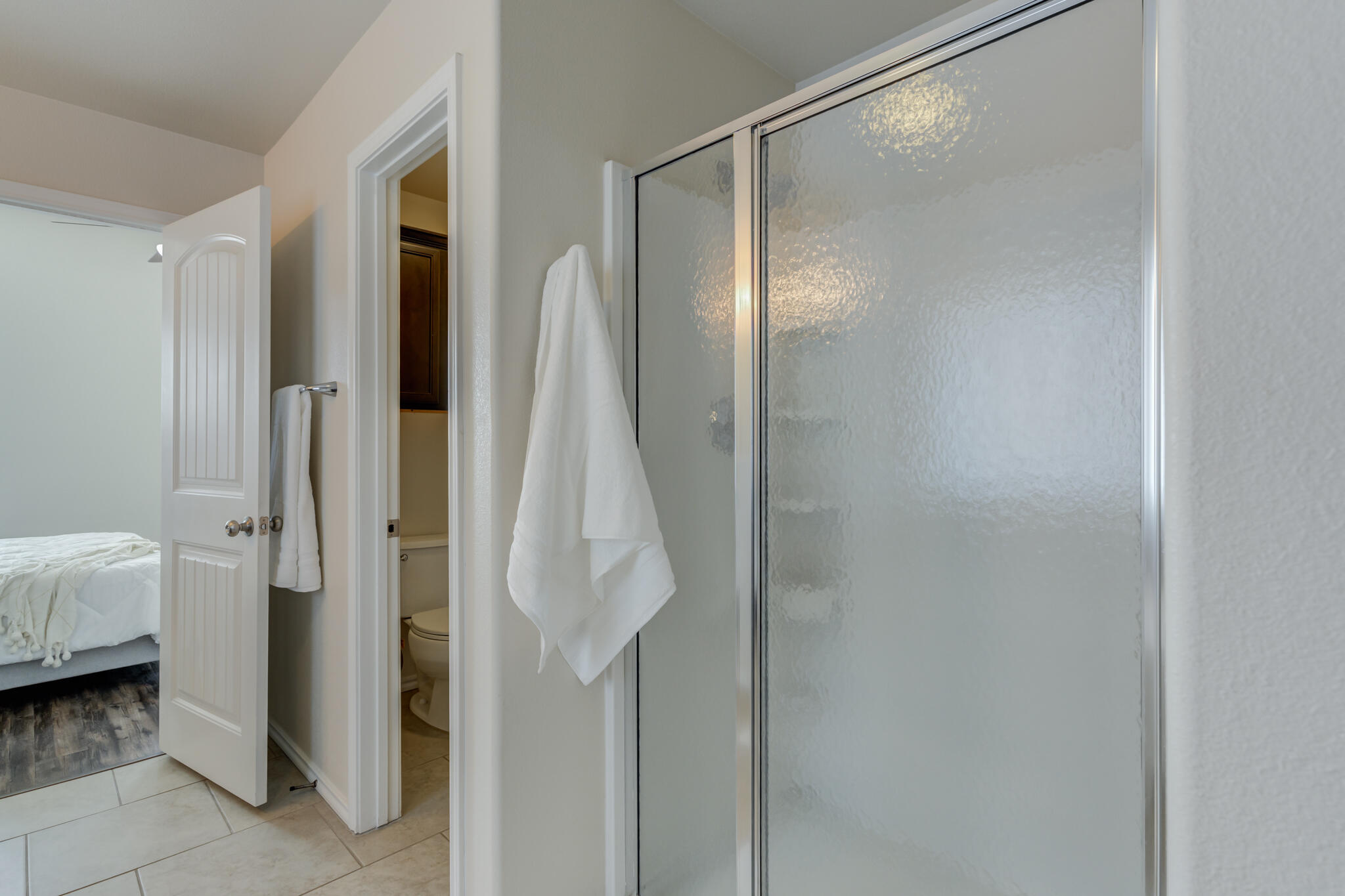 7201 94th Street Lubbock, TX 79424 - Photo 24 of 34 a bathroom with a glass shower door and a sink