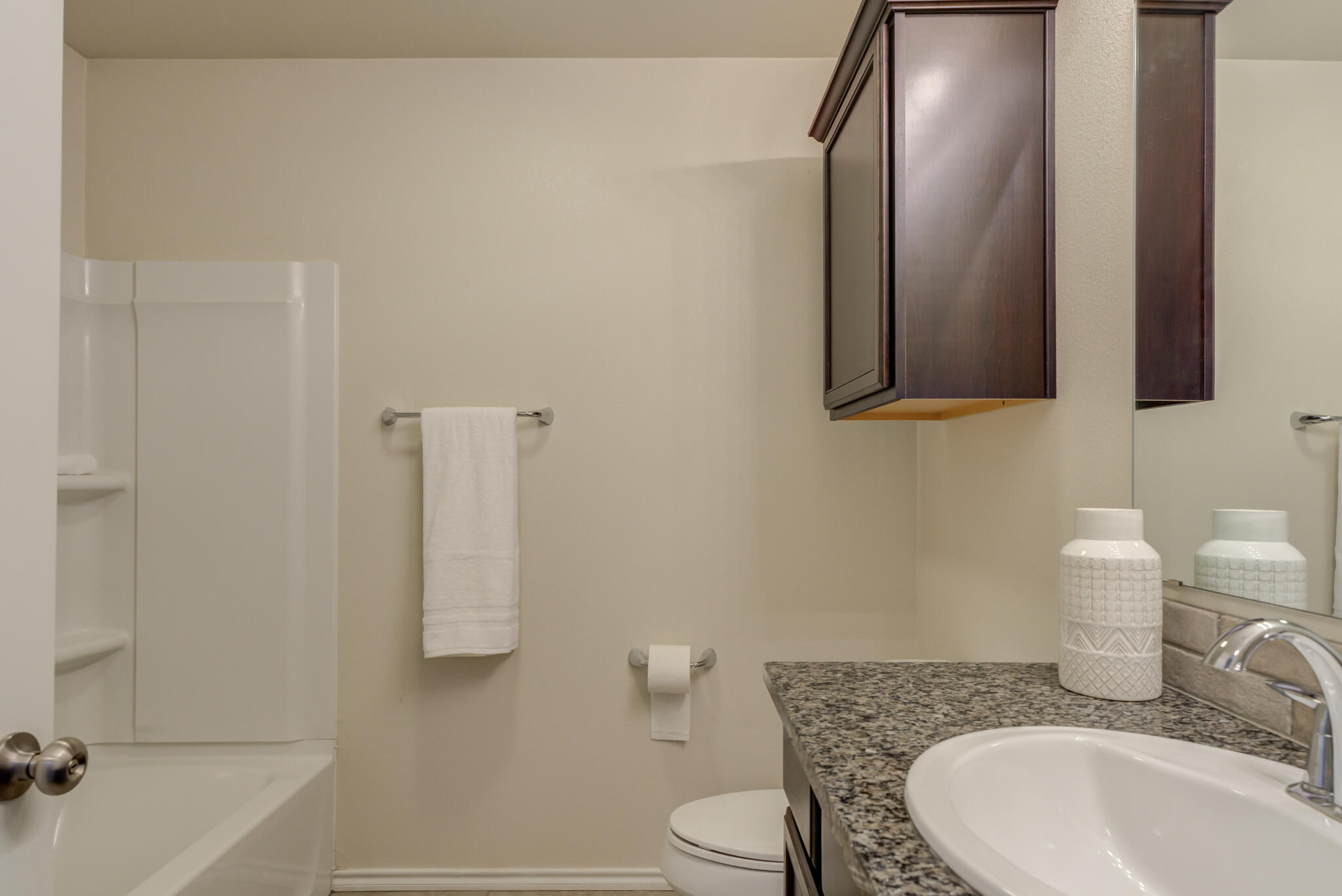 7201 94th Street Lubbock, TX 79424 - Photo 25 of 34 a bathroom with a granite countertop sink and a mirror