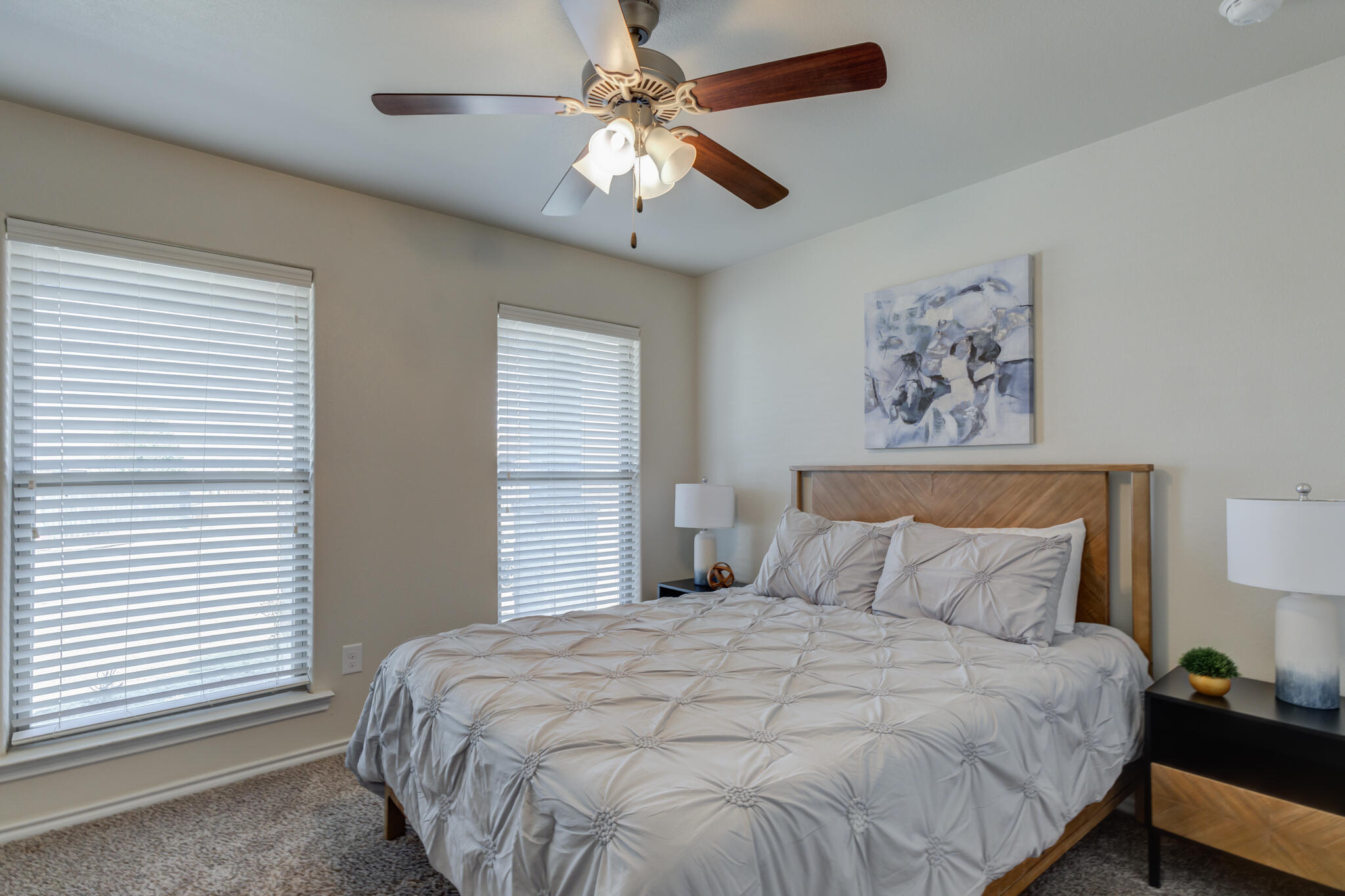 7201 94th Street Lubbock, TX 79424 - Photo 27 of 34 a bedroom with a large bed and a chandelier