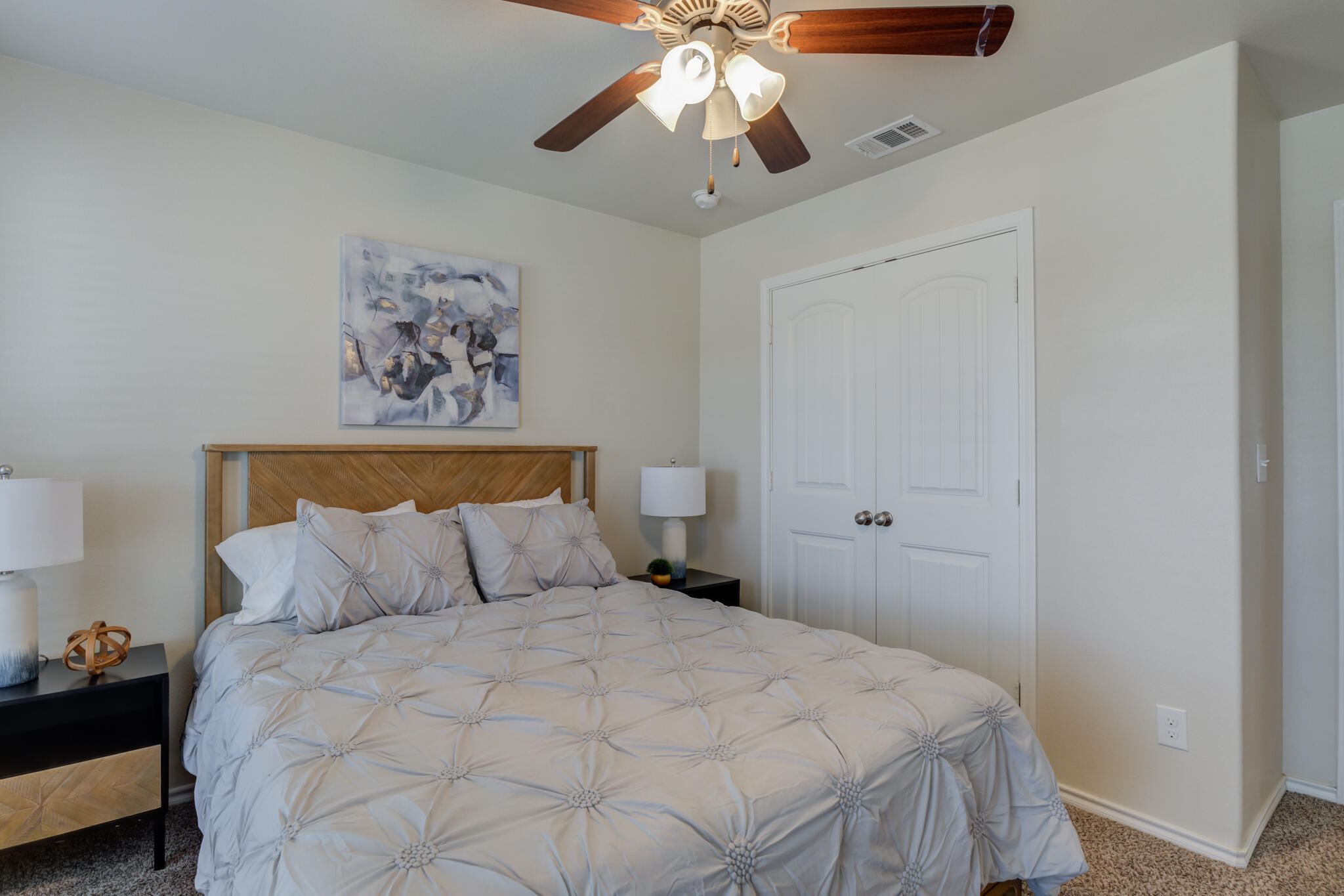 7201 94th Street Lubbock, TX 79424 - Photo 28 of 34 a bedroom with a bed and a chandelier