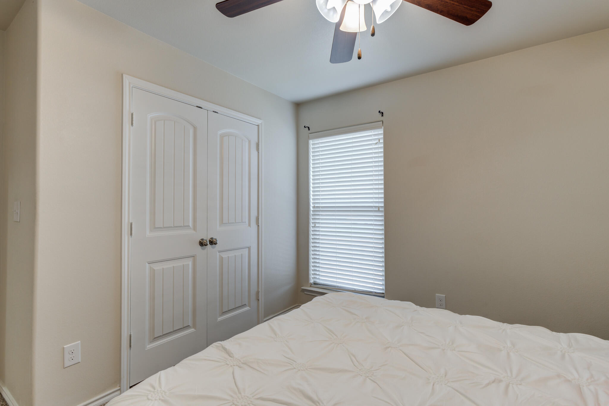 7201 94th Street Lubbock, TX 79424 - Photo 30 of 34 a view of a bedroom with a chandelier fan