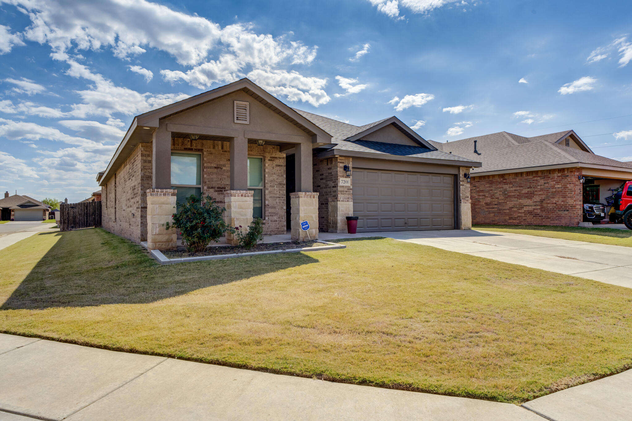 7201 94th Street Lubbock, TX 79424 - Photo 3 of 34 a front view of a house with garage