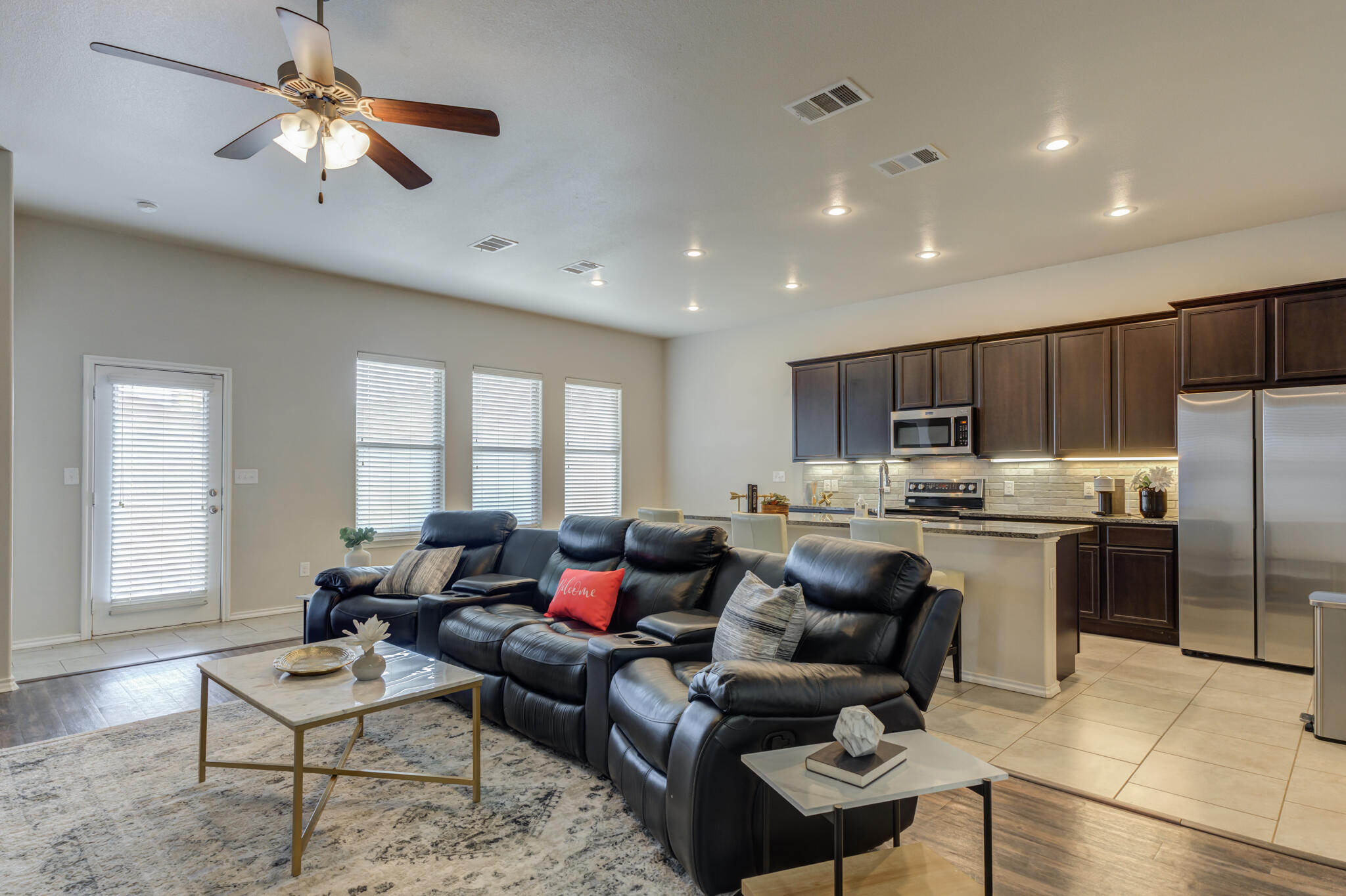 7201 94th Street Lubbock, TX 79424 - Photo 4 of 34 a living room with furniture and kitchen view