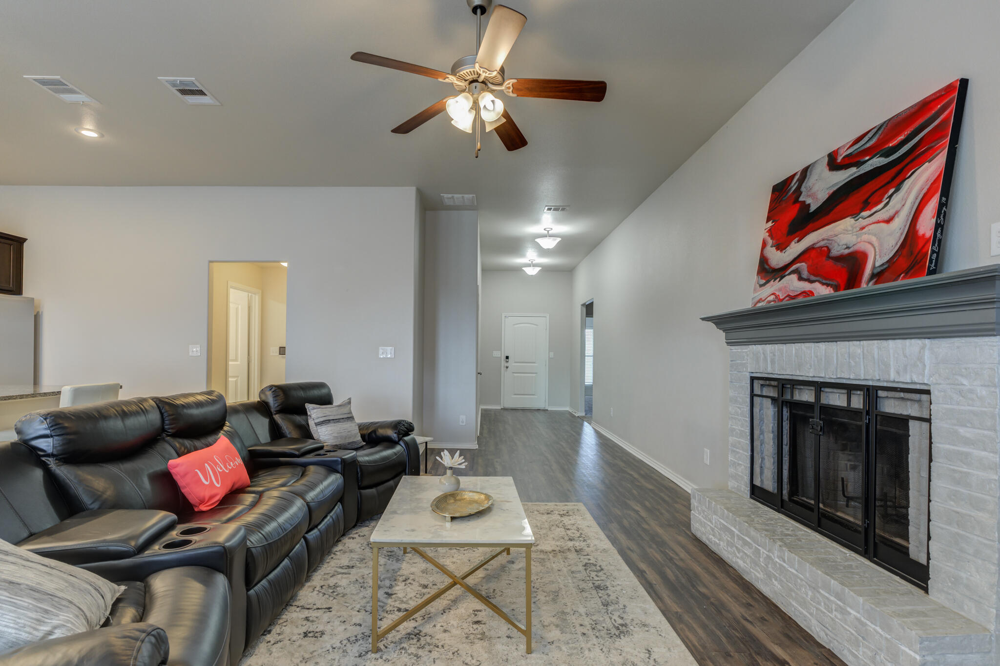 7201 94th Street Lubbock, TX 79424 - Photo 8 of 34 a living room with furniture and a fireplace