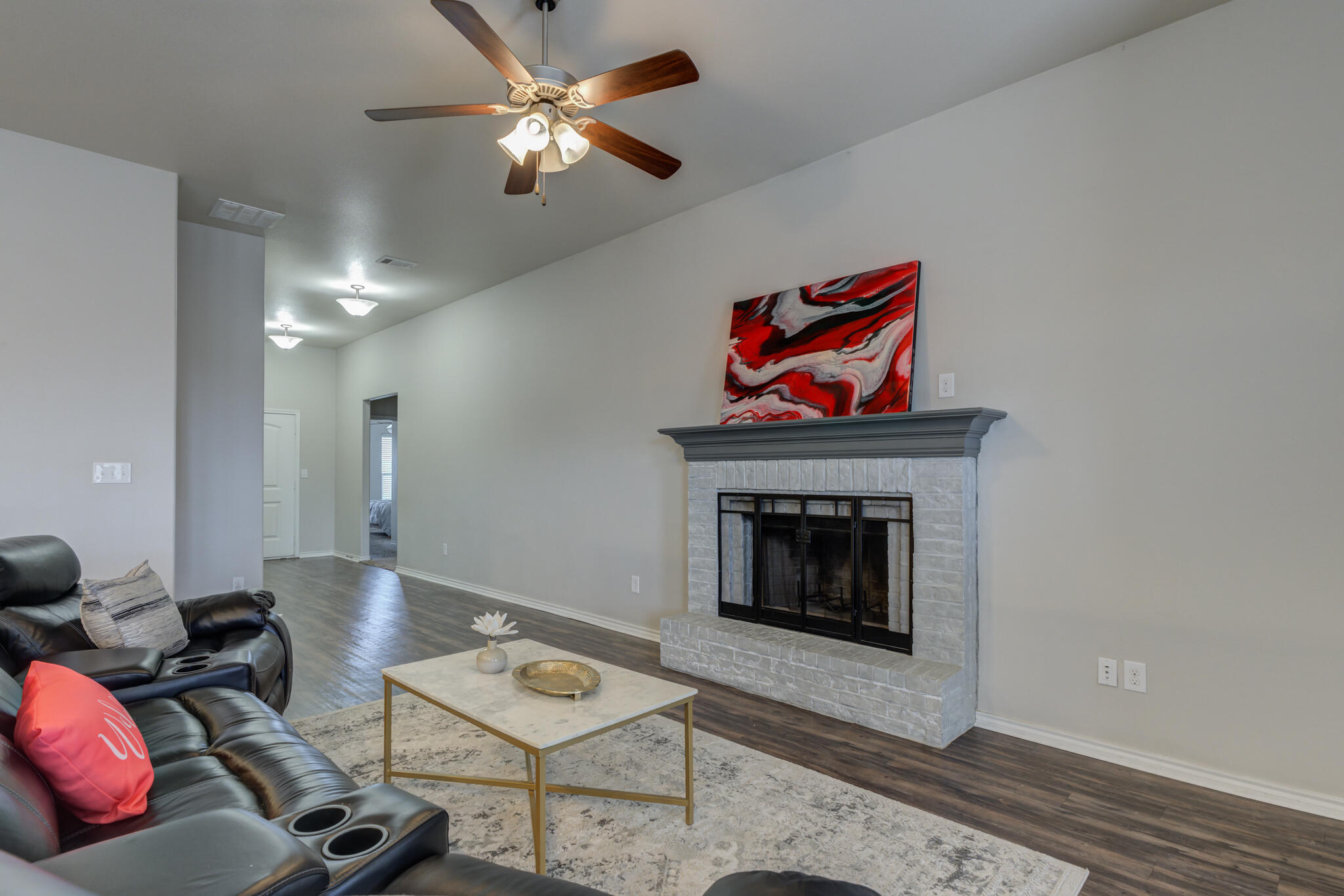 7201 94th Street Lubbock, TX 79424 - Photo 9 of 34 a living room with furniture a rug and a fireplace