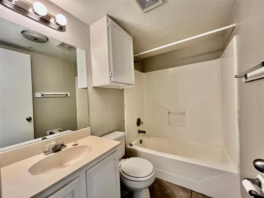 701 West Sycamore Street, Unit 203 Denton, TX 76201 - Photo 6 of 10 a bathroom with a sink toilet and shower