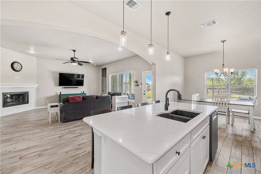 2021 Rustic Manor Drive Temple, TX 76502 - Photo 13 of 30 a kitchen with a stove a sink dishwasher a oven with a dining table and chairs with wooden floor