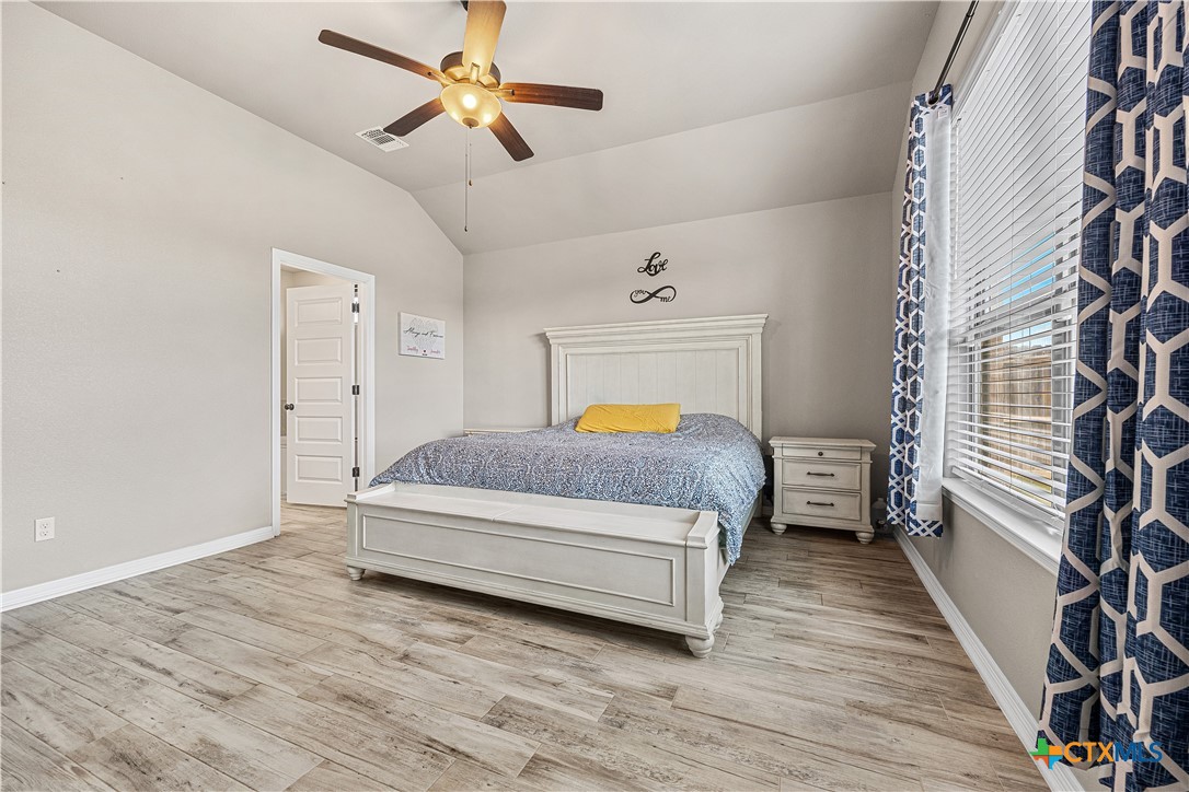 2021 Rustic Manor Drive Temple, TX 76502 - Photo 15 of 30 a bedroom with a bed and wooden floor