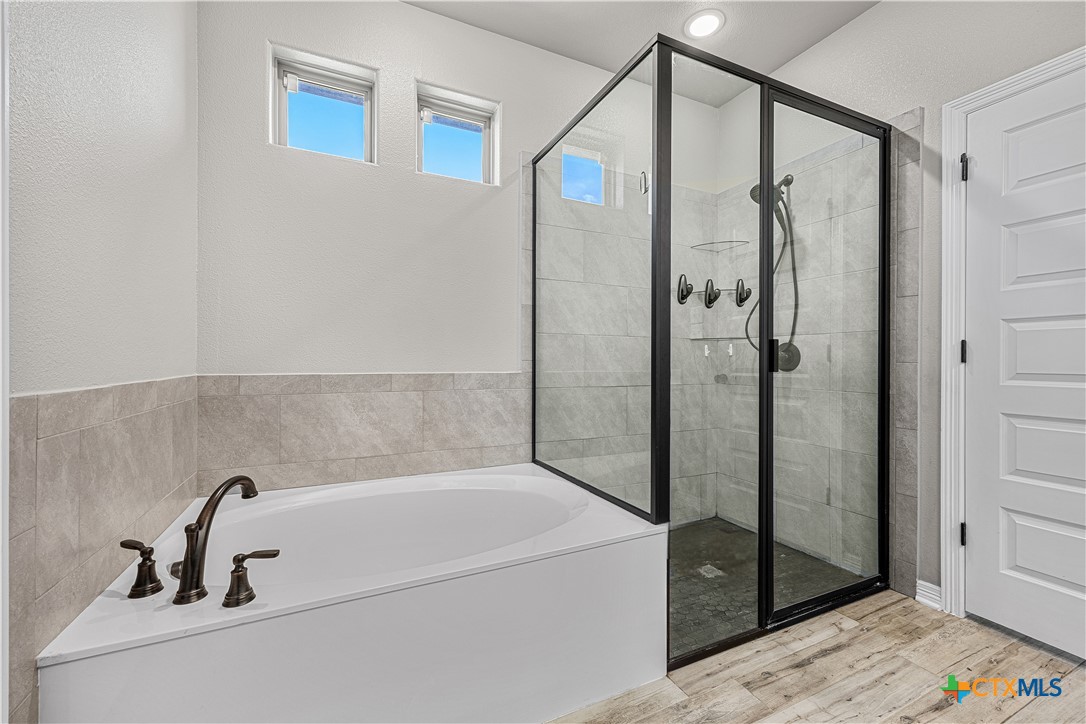 2021 Rustic Manor Drive Temple, TX 76502 - Photo 16 of 30 a bathroom with a bathtub and a shower