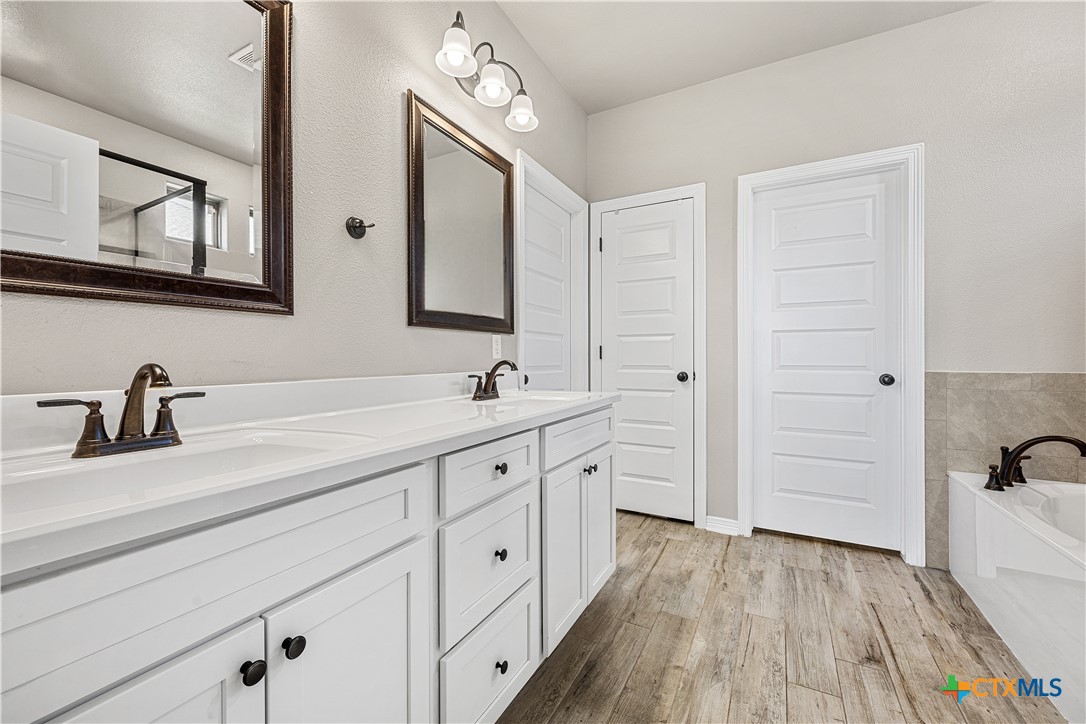 2021 Rustic Manor Drive Temple, TX 76502 - Photo 17 of 30 a spacious bathroom with a double vanity sink a mirror and shower
