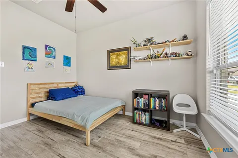 a bedroom with furniture and a book shelf