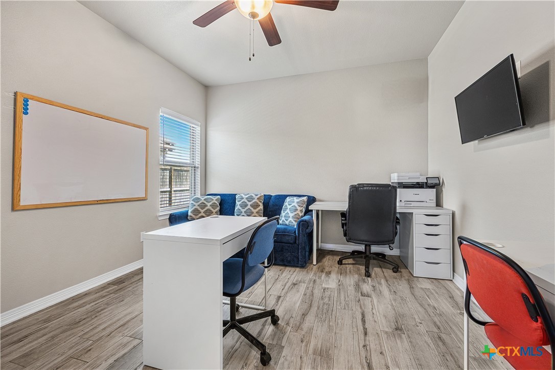 2021 Rustic Manor Drive Temple, TX 76502 - Photo 20 of 30 a view of a workspace with furniture and a flat screen tv