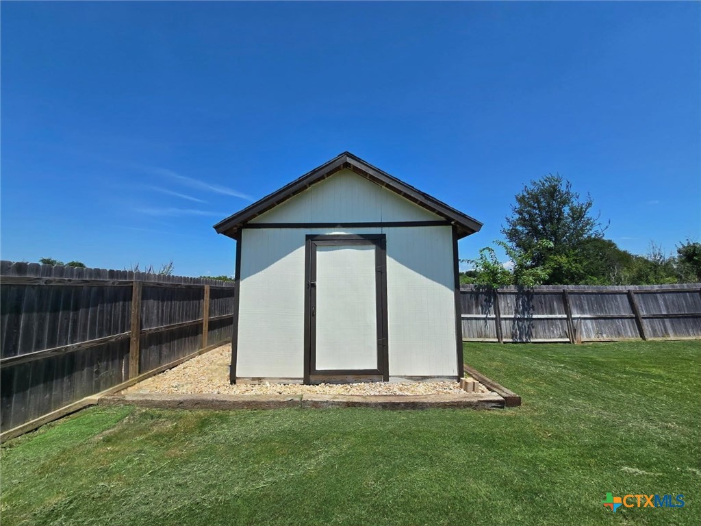 2021 Rustic Manor Drive Temple, TX 76502 - Photo 27 of 30 a front view of a house with a garden and yard