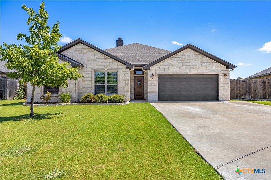 2021 Rustic Manor Drive Temple, TX 76502 - Photo 4 of 30 a front view of a house with a yard and garage