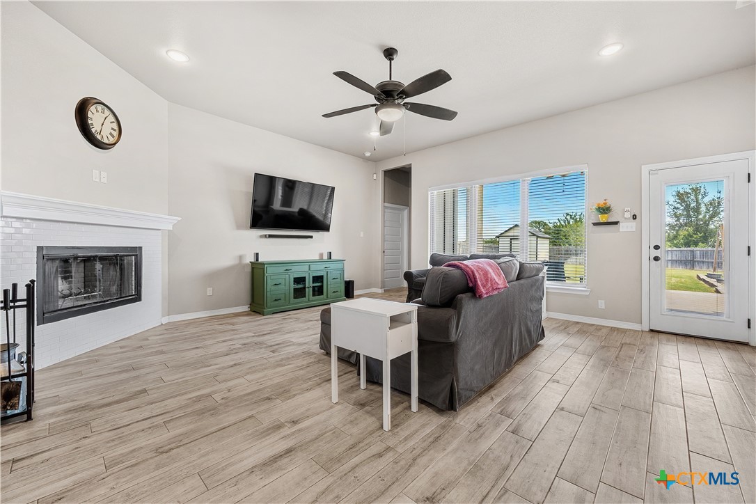 2021 Rustic Manor Drive Temple, TX 76502 - Photo 8 of 30 a living room with furniture a fireplace and a flat screen tv