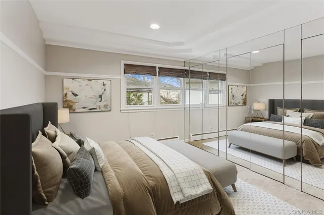 a bedroom with a bed and a large window