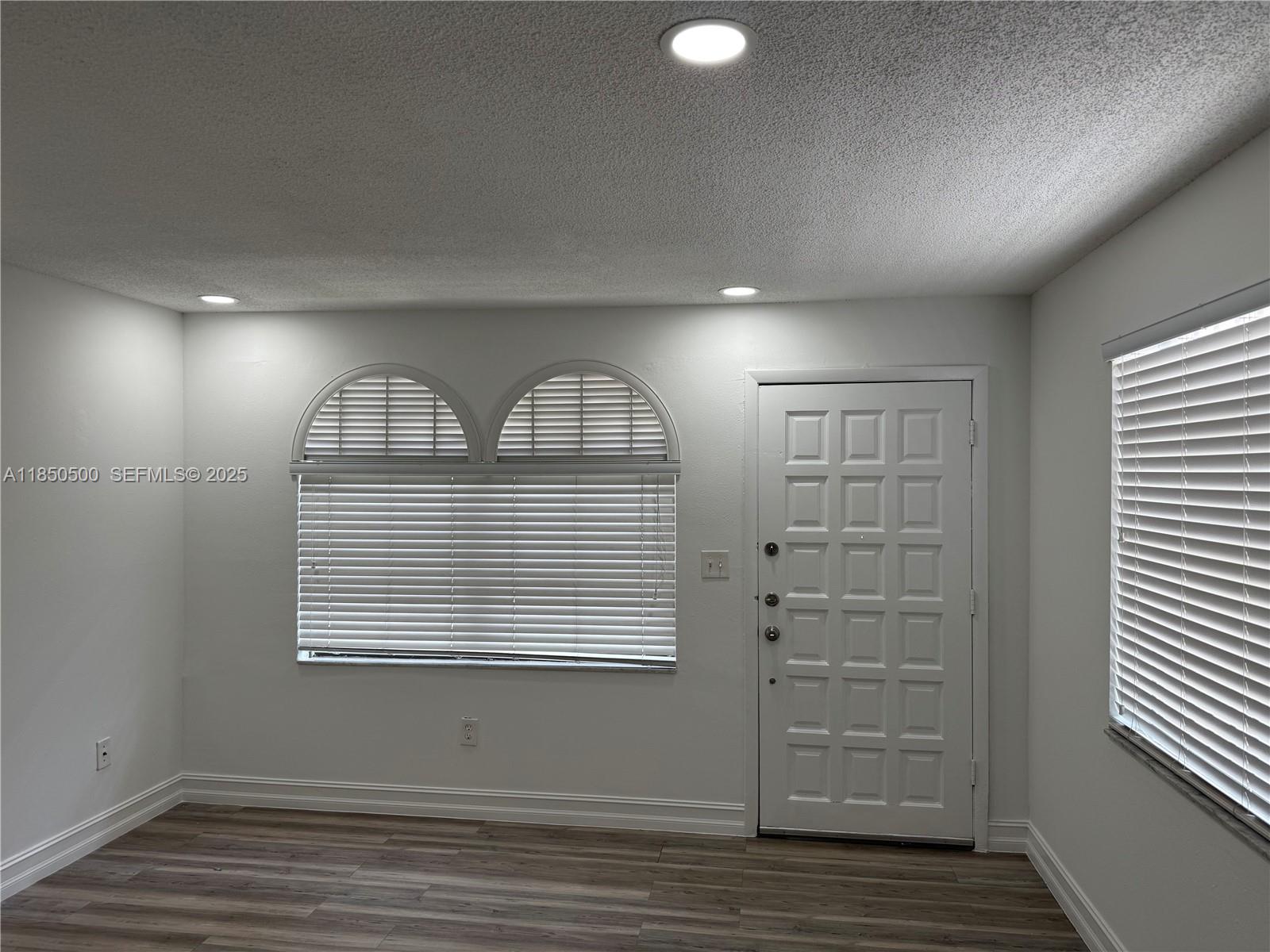 2289 West 52nd Street, Unit 23 Hialeah, FL 33016 - Photo 12 of 23 an empty room with windows