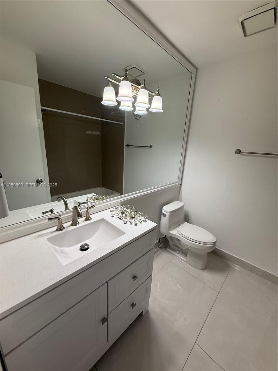 2289 West 52nd Street, Unit 23 Hialeah, FL 33016 - Photo 17 of 23 a bathroom with a double vanity sink and a mirror