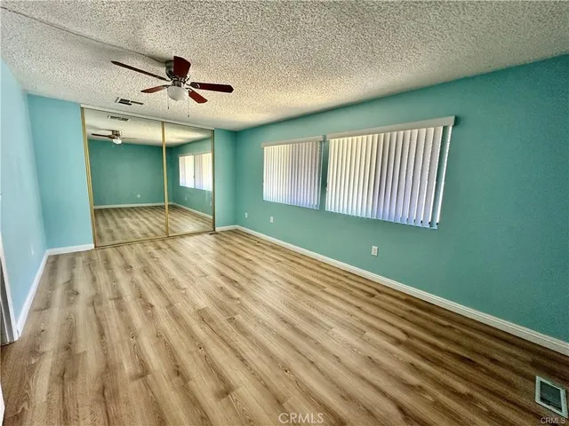 a bedroom with a bed and a ceiling fan