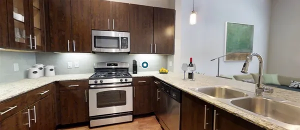 a kitchen with a sink stove and microwave
