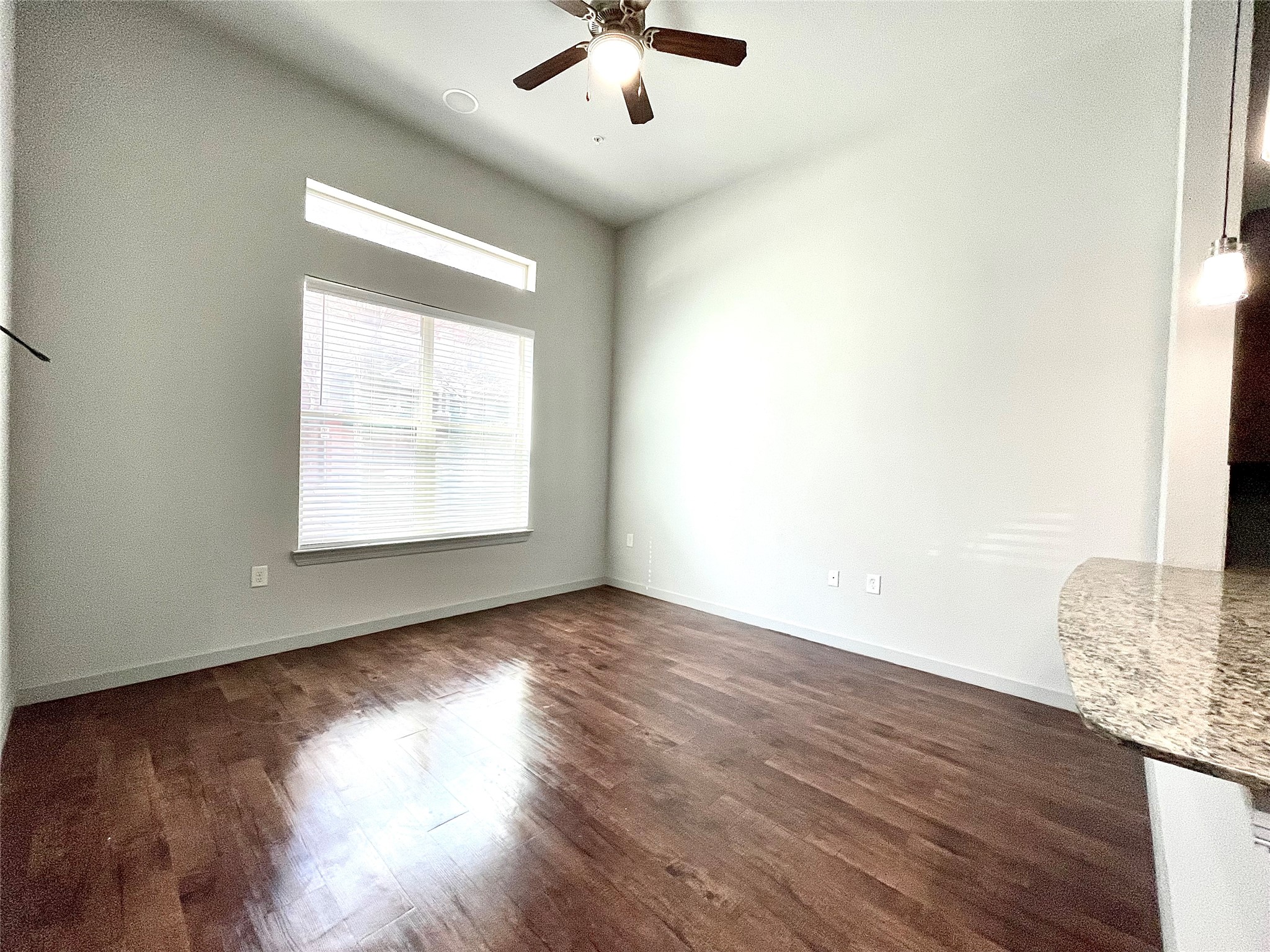 2525 McCue Road, Unit 153 Houston, TX 77056 - Photo 2 of 32 an empty room with wooden floor chandelier and windows
