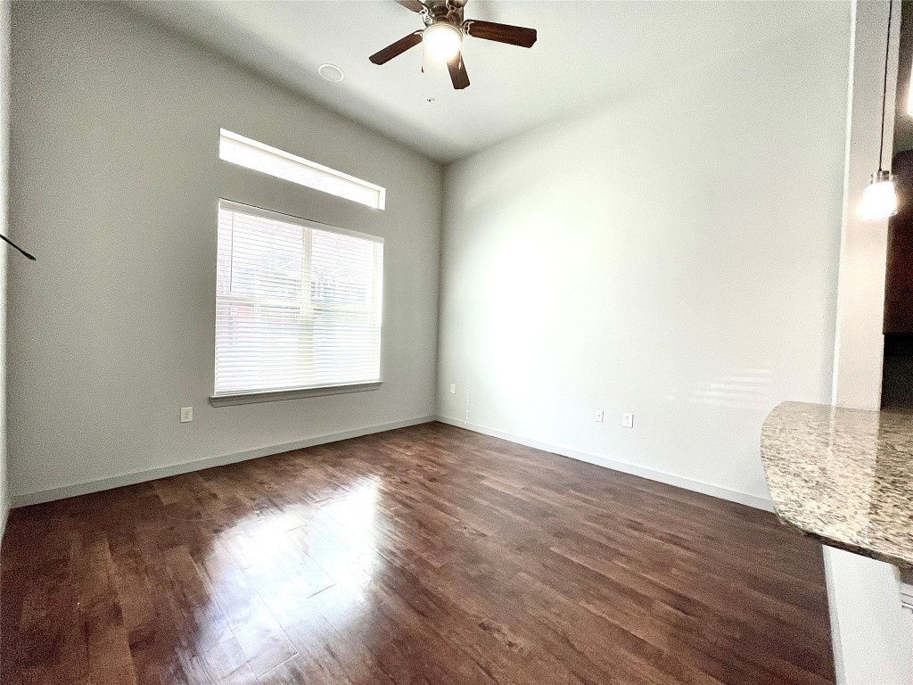 2525 McCue Road, Unit 112 Houston, TX 77056 - Photo 2 of 32 an empty room with wooden floor chandelier and windows